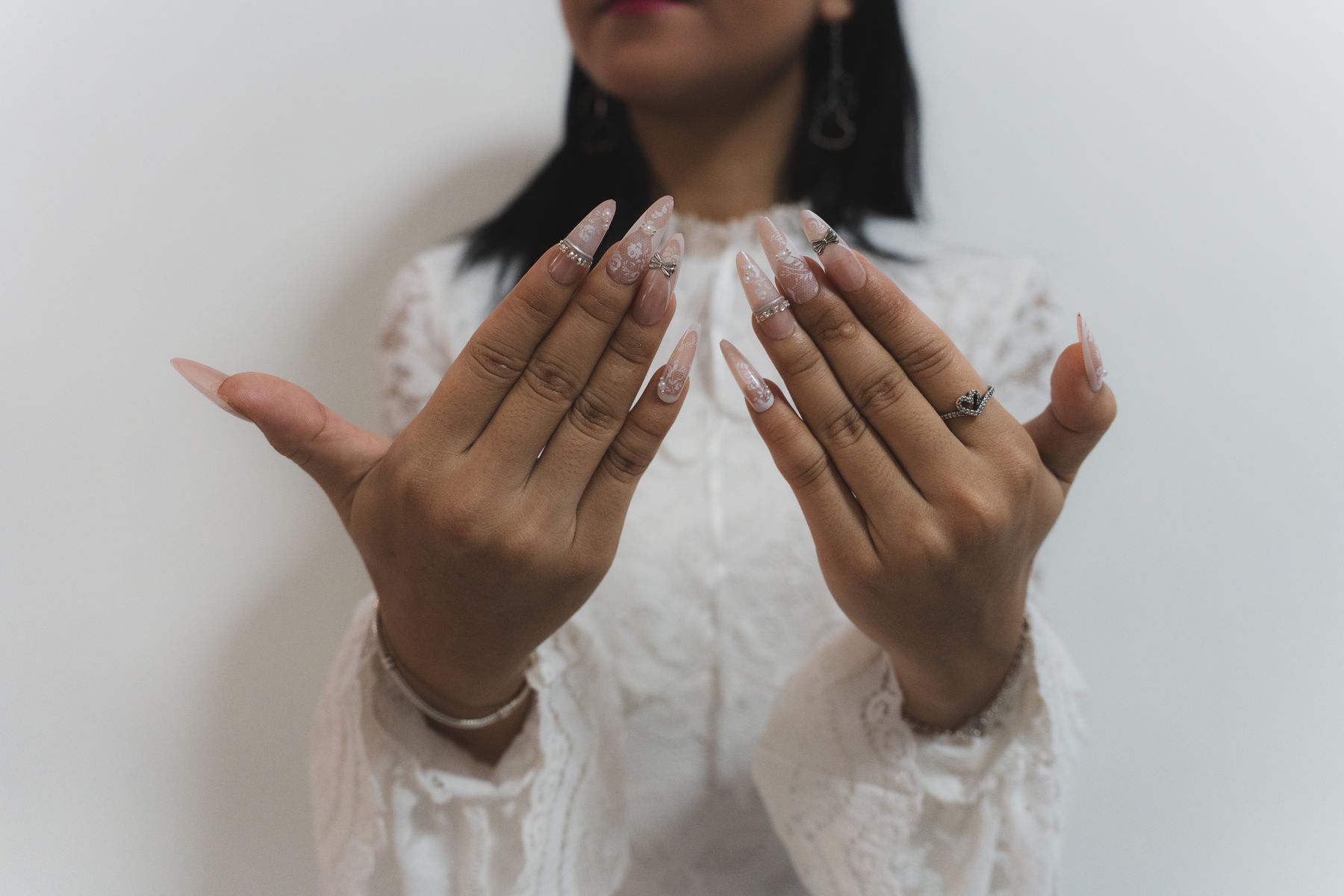 Detail of hands and lace sleeves