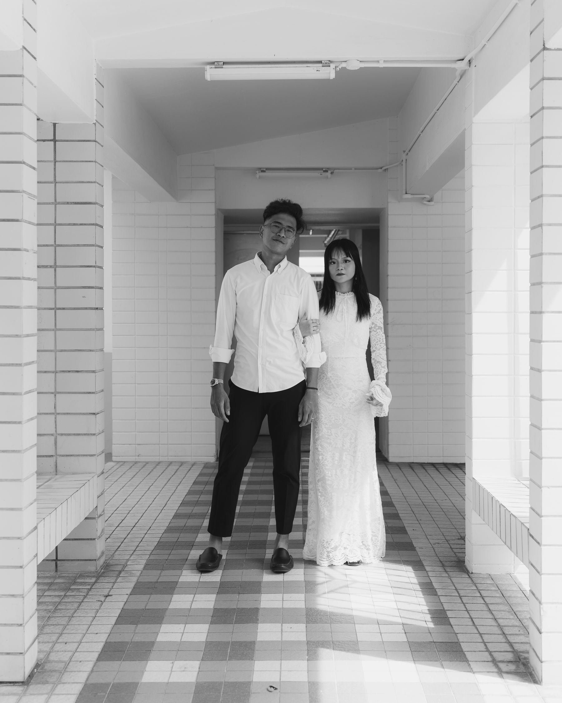 The couple in a sunlit corridor, black and white