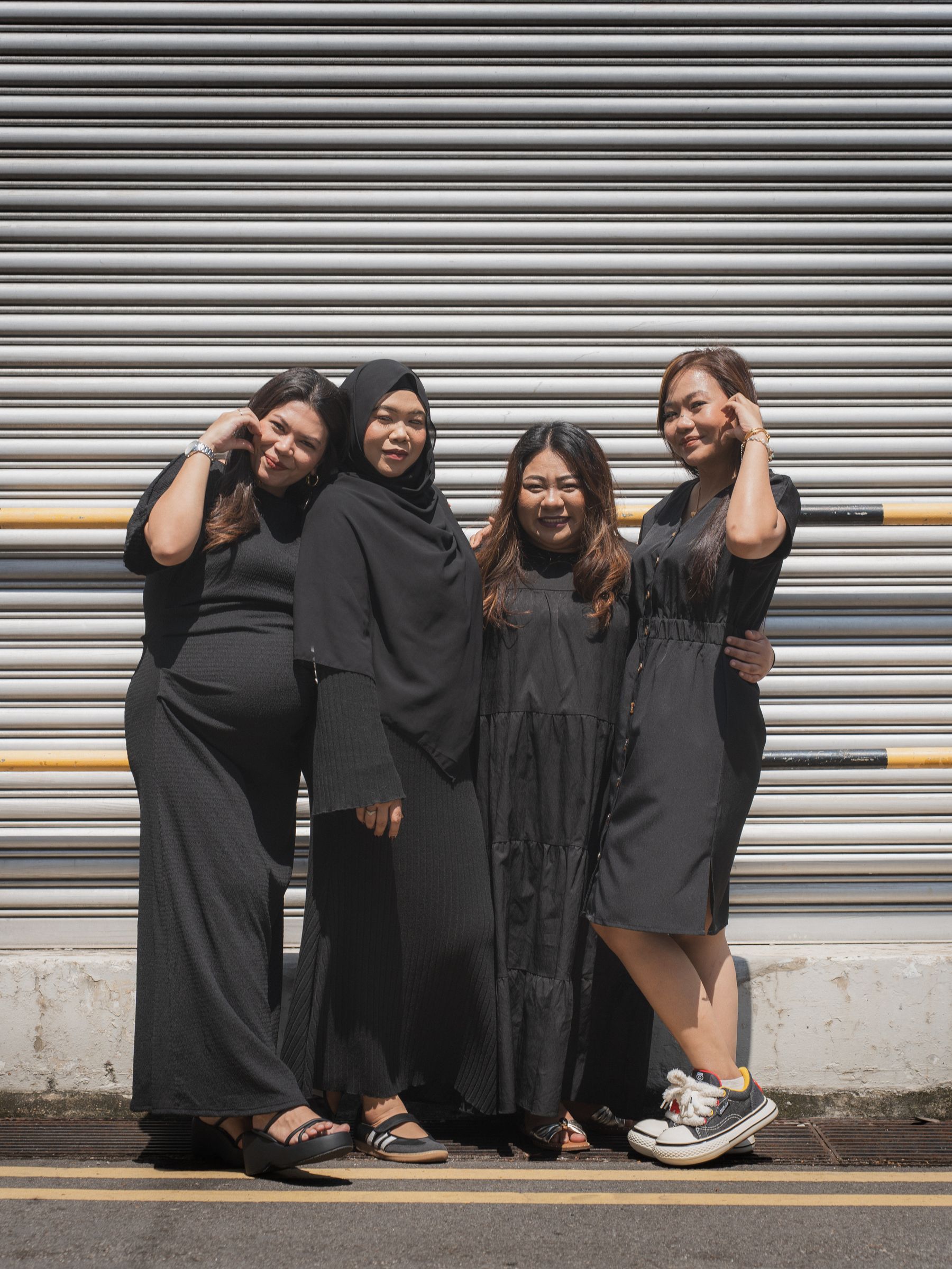 Group laughing against a shutter door
