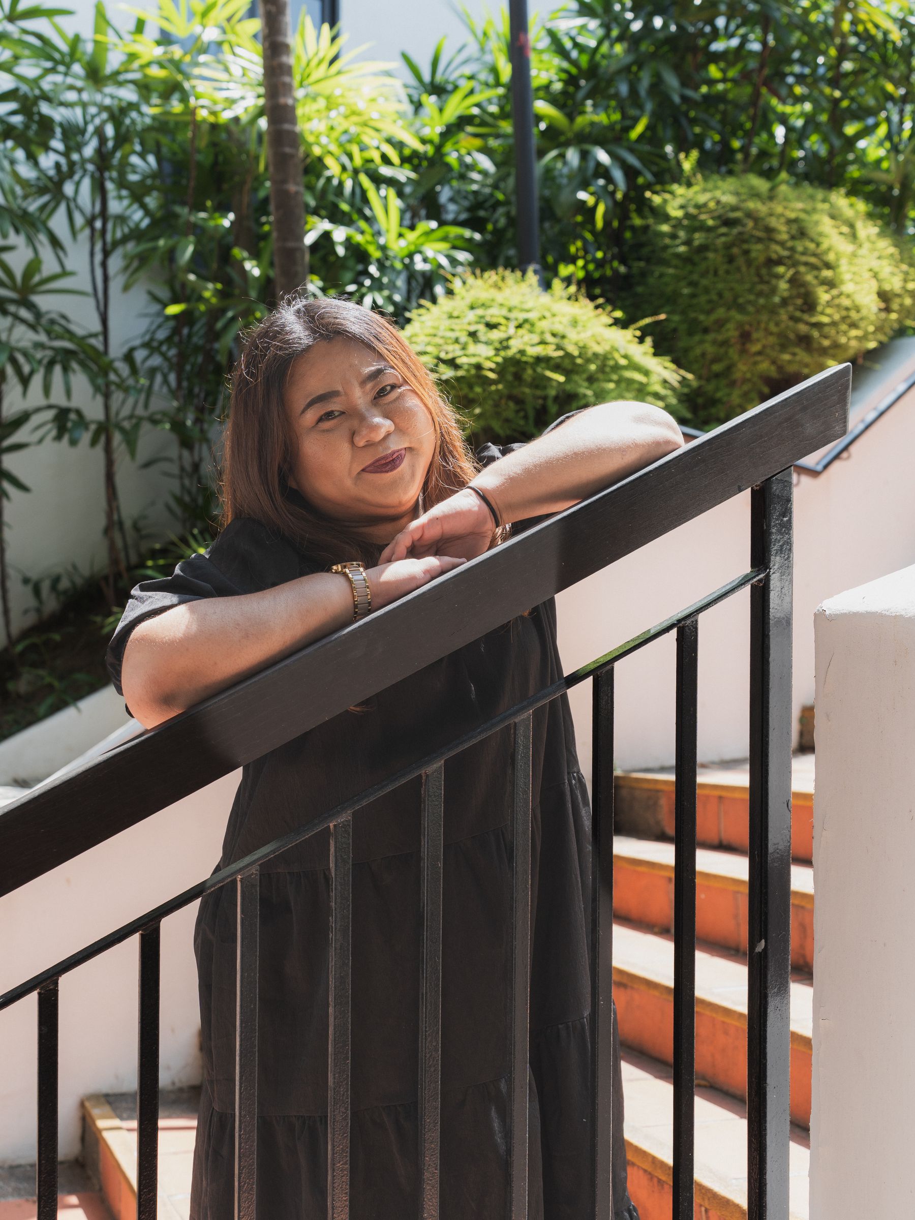 Candid laugh leaning on a railing