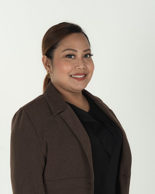 Audadi in a brown blazer, hair tied back