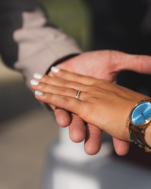 Hands together, showing the wedding ring