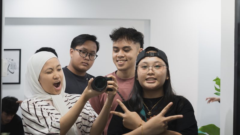 A group crowding into a mirror selfie