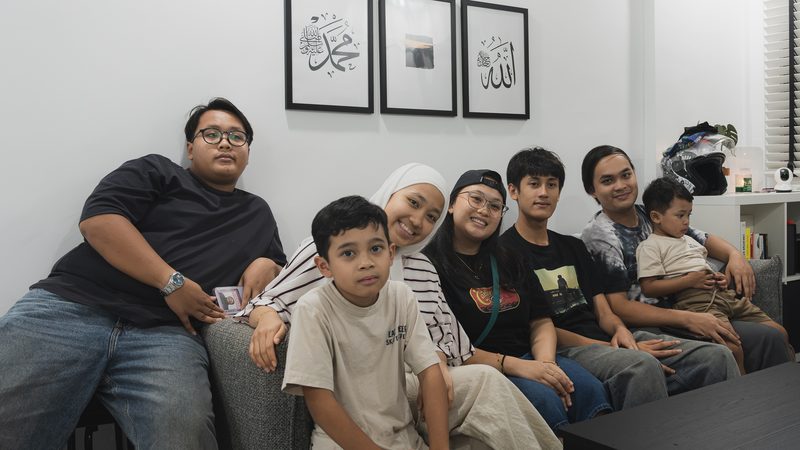 The family gathered on the sofa