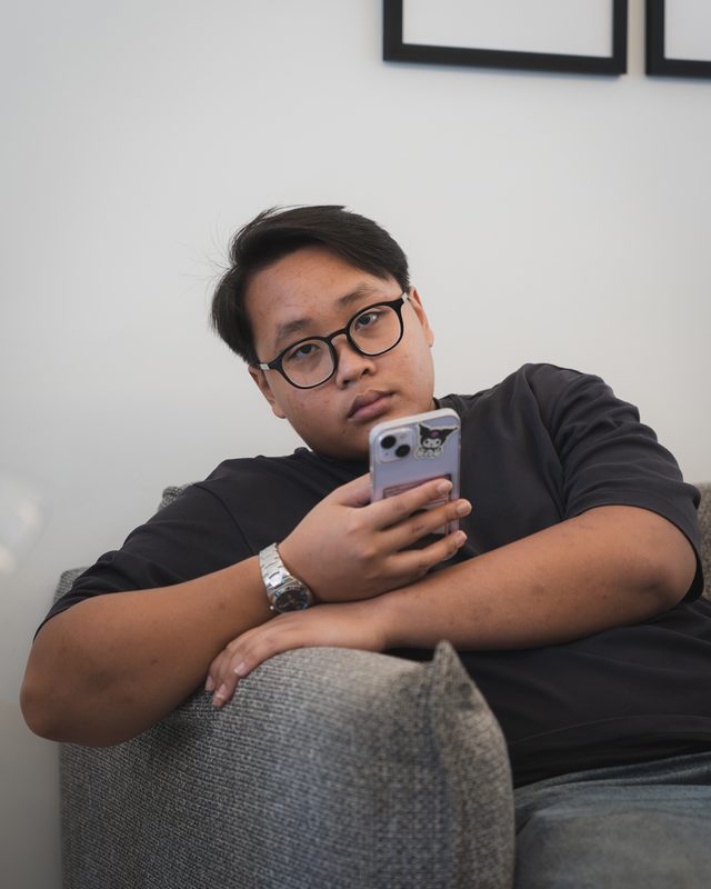 Scrolling a phone on the sofa
