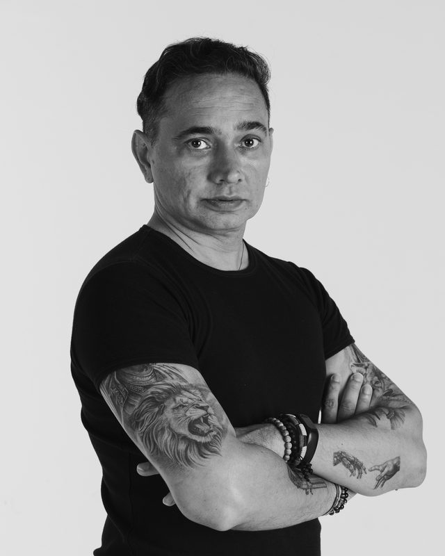 Renay with tattooed arms crossed, black and white