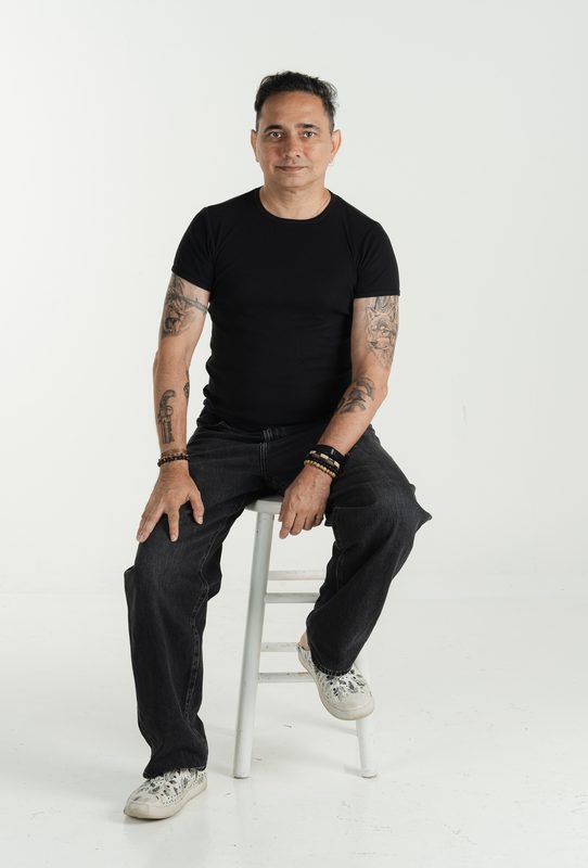 Renay seated on a stool, full length