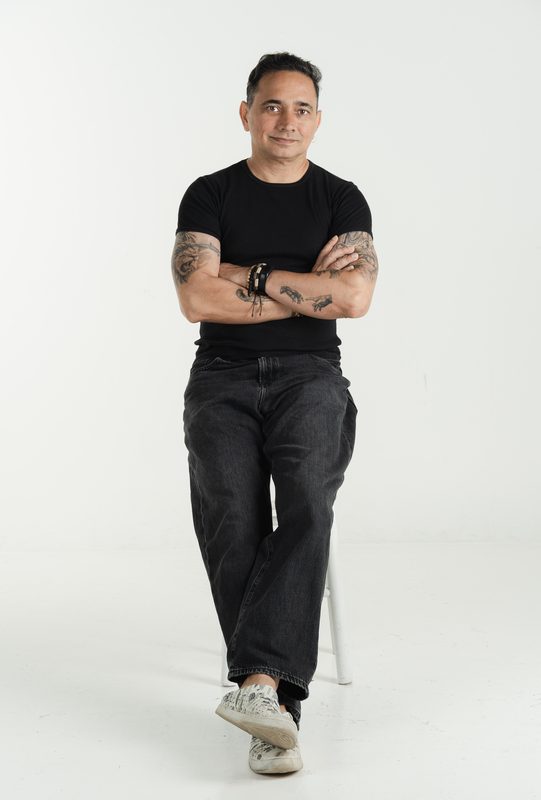 Renay on a stool with arms crossed