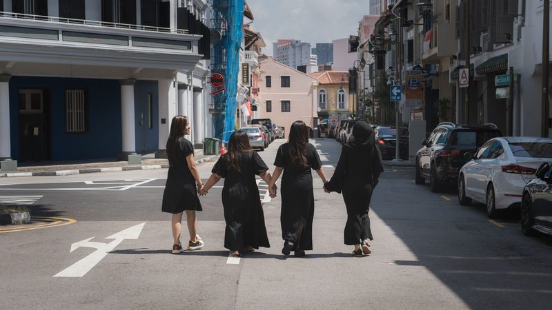 The four of them walking down a heritage street